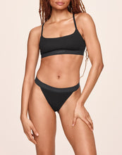 Load image into Gallery viewer, nueskin Tess Rib Cotton Mid-Rise Thong in color Jet Black and shape thong
